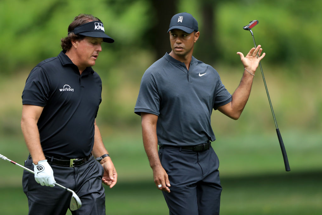 Phil Mickelson (L) and Tiger Woods meet during a preview day of the World Golf Championships - Bridgestone Invitational at Firestone Country Club South Course at on August 1, 2018 in Akron, Ohio. (Photo by Sam Greenwood/Getty Images)