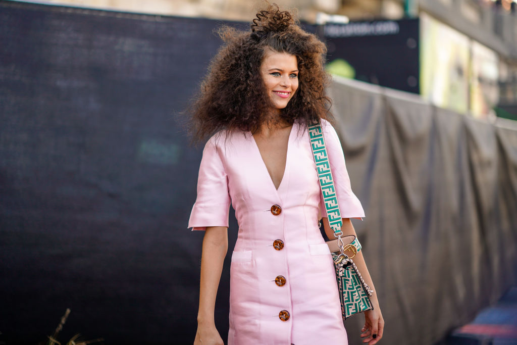PARIS, FRANCE - SEPTEMBER 30:  Georgia Fowler wears a pink dress and a green Fendi bag, outside l'Oreal, during Paris Fashion Week Womenswear Spring/Summer 2019, on September 30, 2018 in Paris, France.  (Photo by Edward Berthelot/Getty Images)