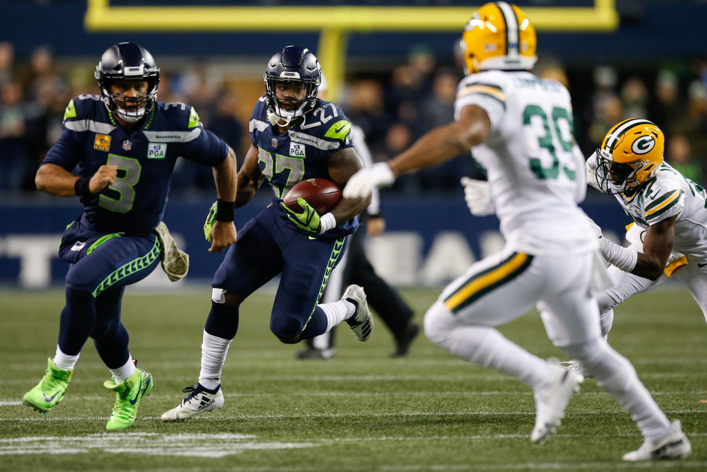 SEATTLE, WA - NOVEMBER 15: Russell Wilson #3 of the Seattle Seahawks runs out front to block Ibraheim Campbell #39 of the Green Bay Packers for Mike Davis #27 of the Seattle Seahawks at CenturyLink Field on November 15, 2018 in Seattle, Washington. (Photo by Otto Greule Jr/Getty Images)
