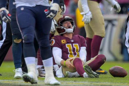 Washington Redskins quarterback Alex Smith (11) reacts to an injury in the third quarter during a game between the Washington Redskins  and the Houston Texans at FedEX Field on November 18, 2018, in Landover, MD. (Photo by John McDonnell/The Washington Post via Getty Images)