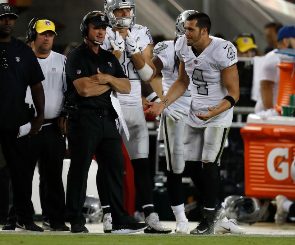 Oakland Raiders starting quarterback Derek Carr #4 talks to Oakland Raiders head coach Jon Gruden on the sidelines after Carr was pulled from the game against the San Francisco 49ers in the fourth quarter at Levi's Stadium on Thursday, Nov. 1, 2018 in Santa Clara, California.  (Nhat V. Meyer/Digital First Media/The Mercury News via Getty Images)