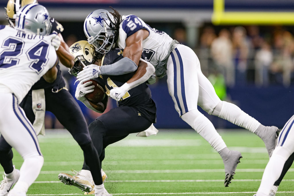 ARLINGTON, TX - NOVEMBER 29: New Orleans Saints Running Back Alvin Kamara (41) is hit by Dallas Cowboys Linebacker Jaylon Smith (54) during the game between the Dallas Cowboys and New Orleans Saints on November 29, 2018 at AT&T Stadium in Arlington, TX.  (Photo by Andrew Dieb/Icon Sportswire via Getty Images)