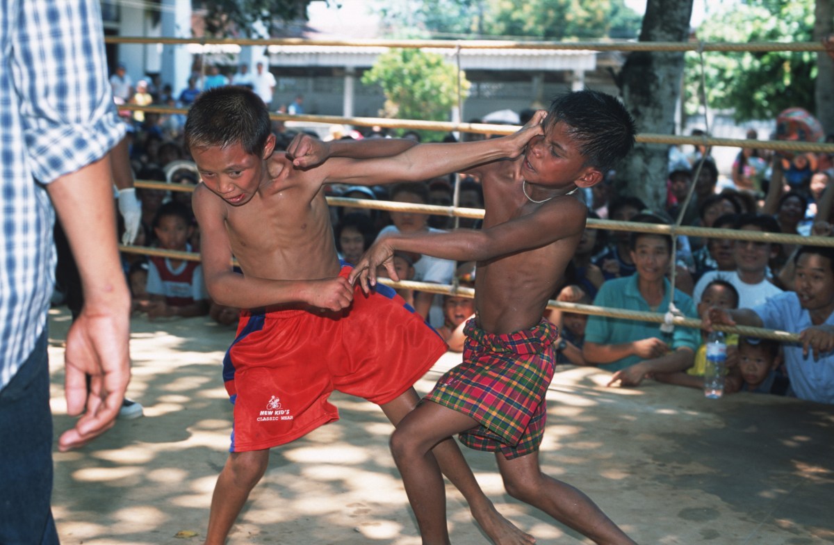 MAE KON KEN VILLAGE, THAILAND - 2003/04/01: A fight between a young Thai and a Burmese boxer at a Buddhist temple in Mae Kon Ken village, close to the Thai-Burmese border. (Photo by Gerhard Joren/LightRocket via Getty Images)