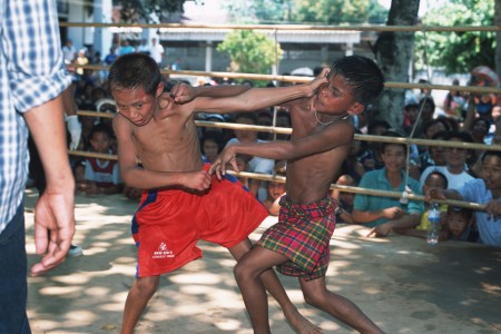 MAE KON KEN VILLAGE, THAILAND - 2003/04/01: A fight between a young Thai and a Burmese boxer at a Buddhist temple in Mae Kon Ken village, close to the Thai-Burmese border. (Photo by Gerhard Joren/LightRocket via Getty Images)