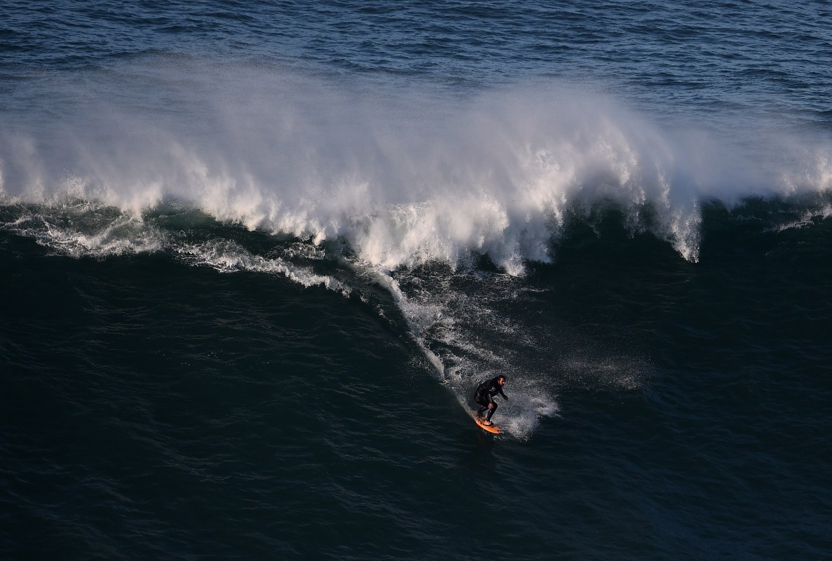 Brazilian big wave surfer Rodrigo Koxa drops a wave at Nazare's North Beach on November 29, 2014.   AFP PHOTO/ FRANCISCO LEONG        (Photo credit should read FRANCISCO LEONG/AFP/Getty Images)