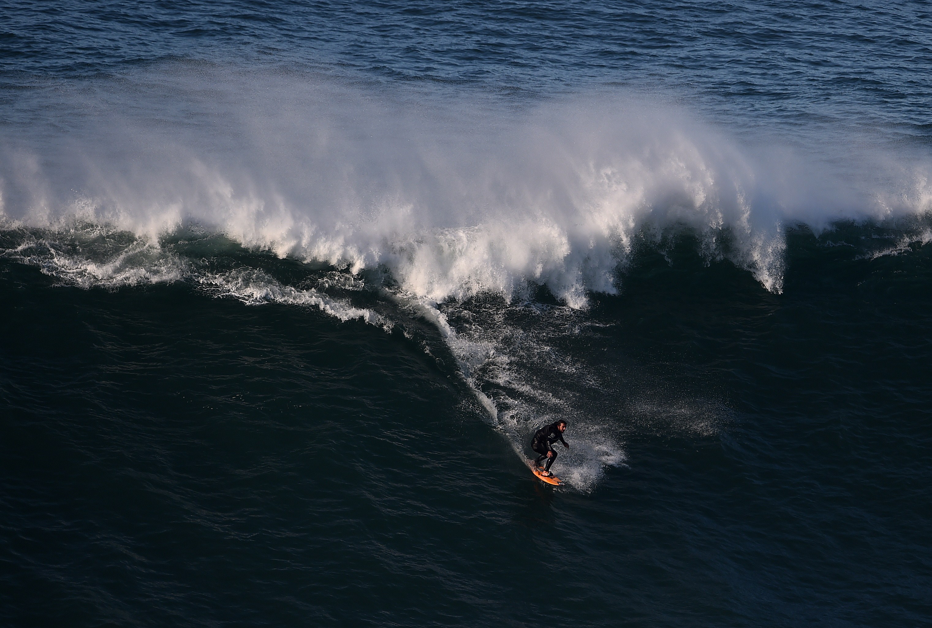 Brazilian big wave surfer Rodrigo Koxa drops a wave at Nazare's North Beach on November 29, 2014. AFP PHOTO/ FRANCISCO LEONG (Photo credit should read FRANCISCO LEONG/AFP/Getty Images)