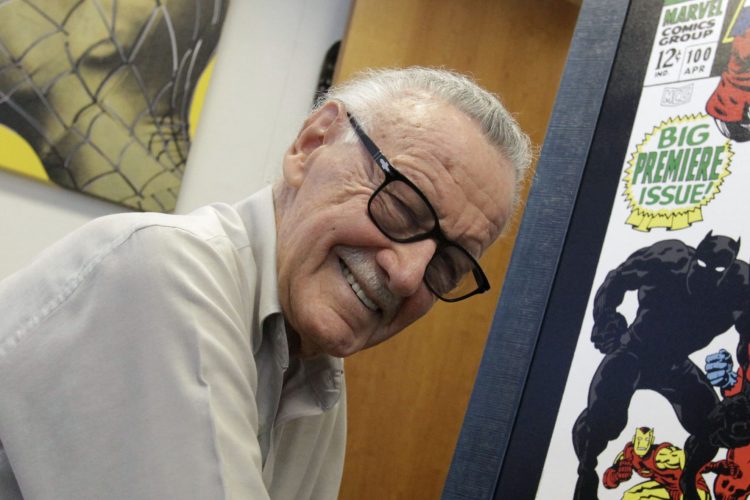 Stan Lee pictured signing poster for an exhibit in his Beverly Hills office in 2009.  (Photo by Barbara Davidson/Los Angeles Times via Getty Images)