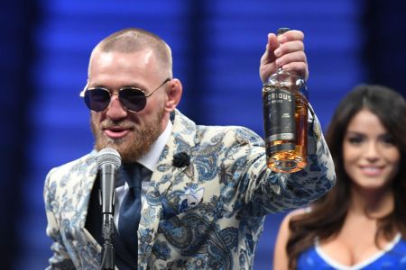 LAS VEGAS, NV - AUGUST 26:  Conor McGregor speaks during a news conference while holding up his Notorious-branded Irish whiskey after his loss to Floyd Mayweather Jr. by 10th-round TKO in their super welterweight boxing match on August 26, 2017 at T-Mobile Arena in Las Vegas, Nevada.  (Photo by Ethan Miller/Getty Images)