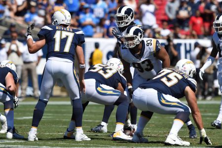 LOS ANGELES, CA - SEPTEMBER 23: Los Angeles Rams Nose Tackle Ndamukong Suh (93) stares down Los Angeles Chargers Quarterback Philip Rivers (17) during an NFL game between the Los Angeles Chargers and the Los Angeles Rams on September 23, 2018, at the Los Angeles Memorial Coliseum in Los Angeles, CA. (Photo by Chris Williams/Icon Sportswire via Getty Images)