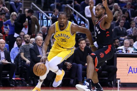 TORONTO, ON - NOVEMBER 29:  Kevin Durant #35 of the Golden State Warriors dribbles the ball as Kawhi Leonard #2 of the Toronto Raptors defends during the second half of an NBA game at Scotiabank Arena on November 29, 2018 in Toronto, Canada. (Photo by Vaughn Ridley/Getty Images)