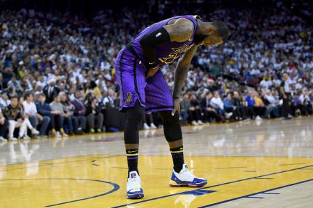OAKLAND, CA - DECEMBER 25:  LeBron James #23 of the Los Angeles Lakers leans over in pain after he was hurt against the Golden State Warriors during the second half of their NBA Basketball game at ORACLE Arena on December 25, 2018 in Oakland, California. (Photo by Thearon W. Henderson/Getty Images)