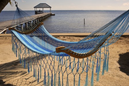 A view of a hammock on the beach on October 24, 2010 in the Island of Ambergris Caye, Belize, Central America.  hammock in carabbean islands, Ambergris Caye, Belize. (Photo by Philippe ROYER/Gamma-Rapho via Getty Images)