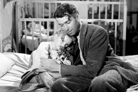 American actors James Stewart (1908 - 1997), as George Bailey, and Karolyn Grimes as his daughter Zuzu, in a scene from 'It's a Wonderful Life', directed by Frank Capra, 1946. (Getty Images)