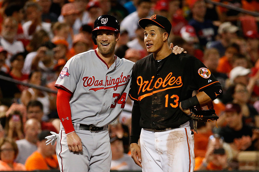 BALTIMORE, MD - JULY 10:  Bryce Harper #34 of the Washington Nationals and Manny Machado #13 of the Baltimore Orioles talk during their game at Oriole Park at Camden Yards on July 10, 2015 in Baltimore, Maryland.  (Photo by Rob Carr/Getty Images)