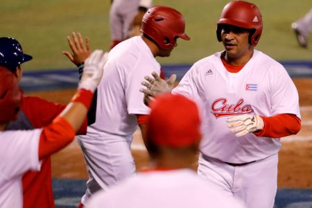 Frederich Cepeda (R) of Alazanes del Granma of Cuba celebrates after scoring against Aguilas Cibaenas of República Dominicana during the Caribbean Baseball Series at the Charros Jalisco stadium in Guadalajara, Jalisco state, Mexico, on February 7, 2018. / AFP PHOTO / ULISES RUIZ        (Photo credit should read ULISES RUIZ/AFP/Getty Images)