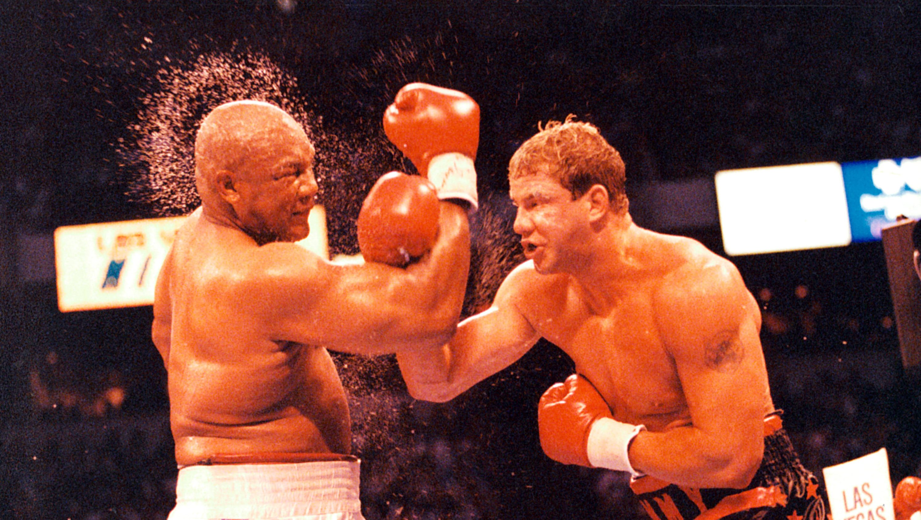 LAS VEGAS - JUNE 7, 1993: Tommy Morrison (R) connects with a right punch against George Foreman at the Thomas & Mack Center, on June 7,1993 in Las Vegas, Nevada. Tommy Morrison won by a UD 12 to claim a share of the heavyweight championship. (The Ring Magazine/Getty Images)