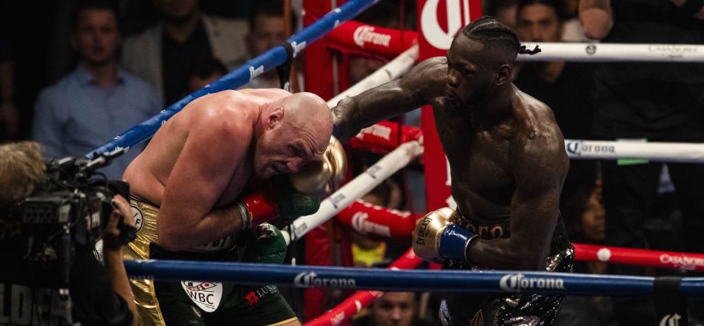 Reigning champion Deontay Wilder (right) lands a right hand against Tyson Fury during a WBC heavyweight title fight at the Staples Center in Los Angeles, California on December 01, 2018.
 (Photo by Philip Pacheco/Anadolu Agency/Getty Images)