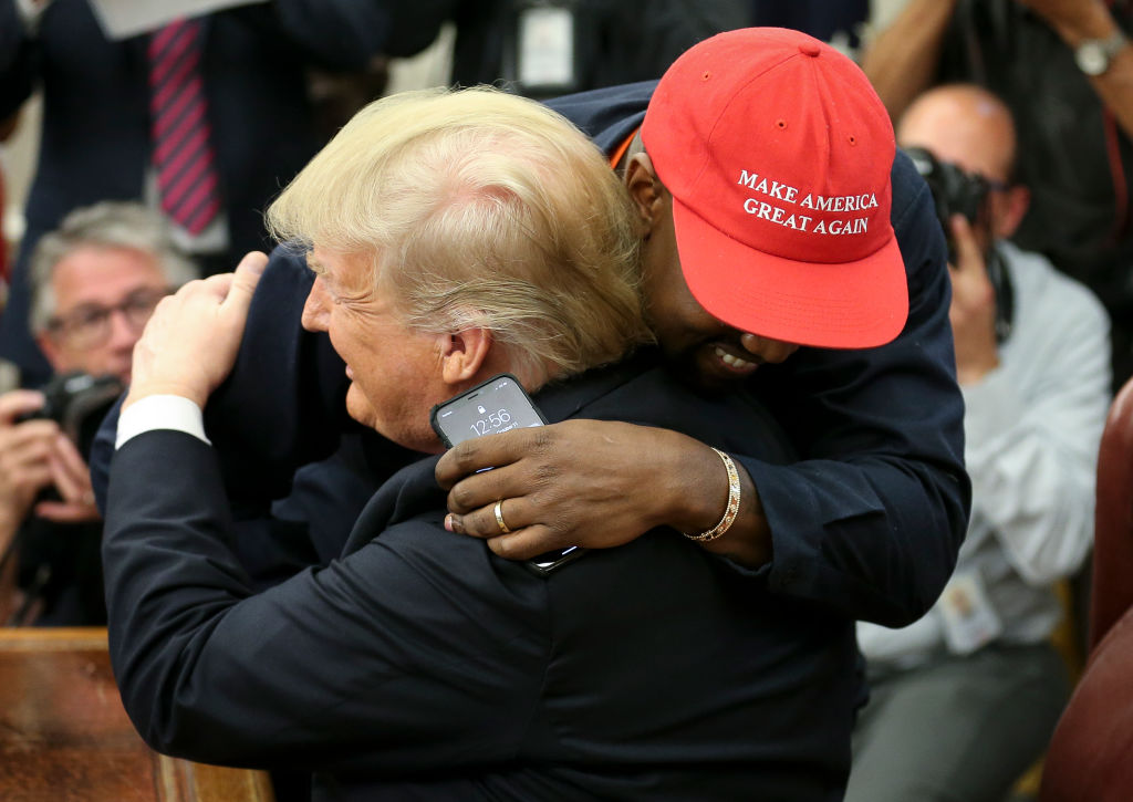 WASHINGTON, DC - OCTOBER 11: U.S. President Donald Trump hugs rapper Kanye West during a meeting in the Oval office of the White House on October 11, 2018 in Washington, DC. (Photo by Oliver Contreras - Pool/Getty Images)