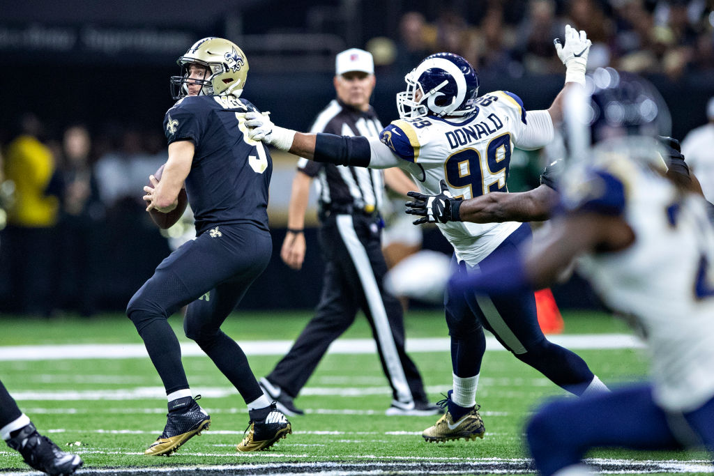 NEW ORLEANS, LA - NOVEMBER 4:  Aaron Donald #99 of the Los Angeles Rams gets a hand on Drew Brees #9 of the New Orleans Saints at Mercedes-Benz Superdome on November 4, 2018 in New Orleans, Louisiana.  The Saints defeated the Rams 45-35.  (Photo by Wesley Hitt/Getty Images)