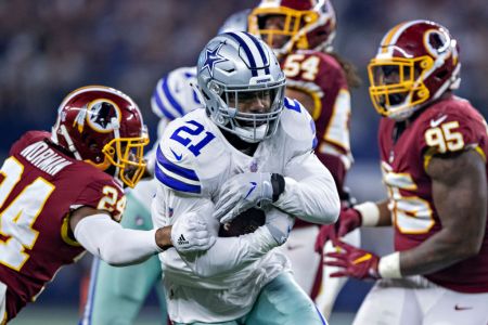 ARLINGTON, TX - NOVEMBER 22:  Ezekiel Elliott #21 of the Dallas Cowboys runs the ball during a game against the Washington Redskins at AT&T Stadium on November 22, 2018 in Arlington, Texas.  The Cowboys defeated the Redskins 31-23.  (Photo by Wesley Hitt/Getty Images)