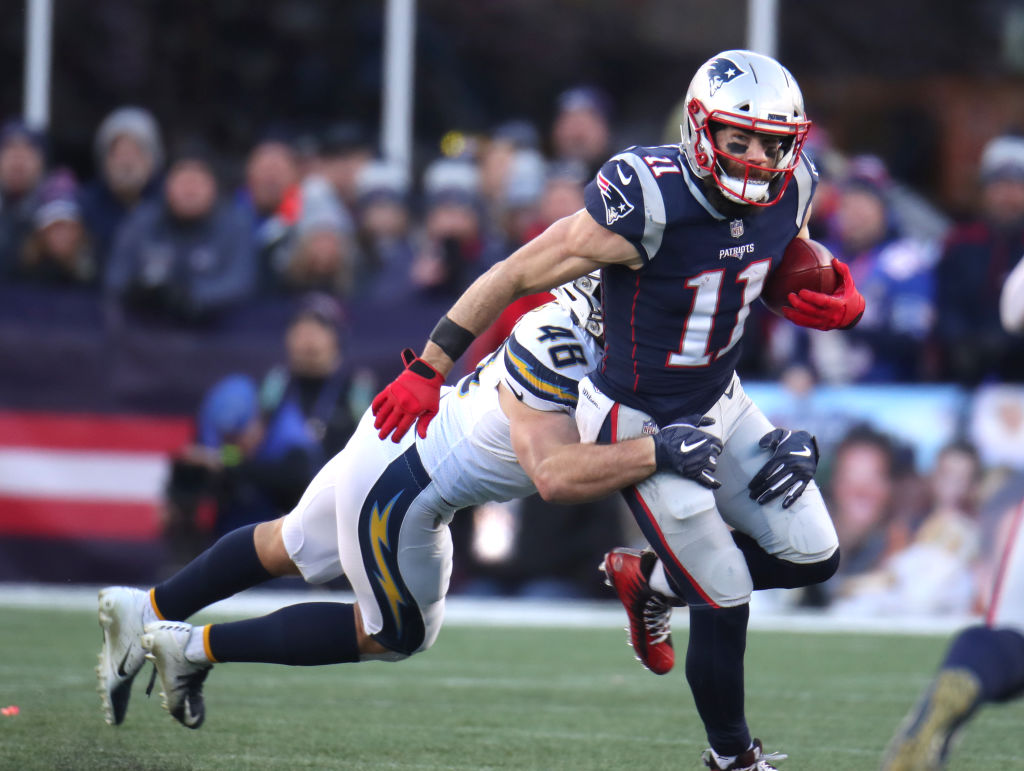 FOXBOROUGH, MA - JANUARY 13: New England Patriots' Julian Edelman is tackled by the Chargers' Nick Dzubnar during the third quarter. The New England Patriots host the Los Angeles Chargers in an NFL AFC Divisional Playoff game at Gillette Stadium in Foxborough, MA on Jan. 13, 2019. (Photo by Stan Grossfeld/The Boston Globe via Getty Images)
