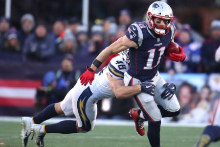 FOXBOROUGH, MA - JANUARY 13: New England Patriots' Julian Edelman is tackled by the Chargers' Nick Dzubnar during the third quarter. The New England Patriots host the Los Angeles Chargers in an NFL AFC Divisional Playoff game at Gillette Stadium in Foxborough, MA on Jan. 13, 2019. (Photo by Stan Grossfeld/The Boston Globe via Getty Images)
