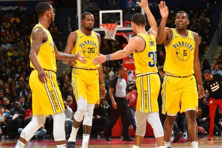 WASHINGTON, DC -  JANUARY 24: Stephen Curry #30 hi-fives Alfonzo McKinnie #28, Kevin Durant #35, and Kevon Looney #5 of the Golden State Warriors on January 24, 2019 at Capital One Arena in Washington, DC. (Photo by Jesse D. GarrabrantNBAE via Getty Images)