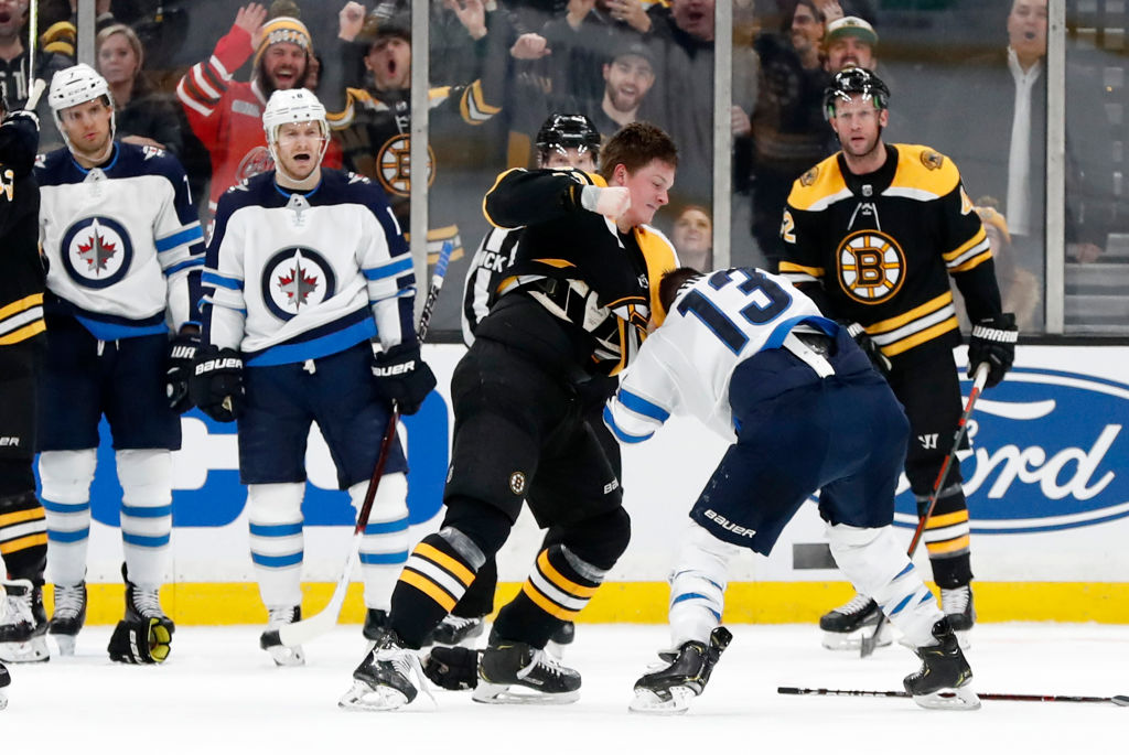 BOSTON, MA - JANUARY 29: Boston Bruins center Trent Frederic (82) punches Winnipeg Jets right wing Brandon Tanev (13) during a game between the Boston Bruins and the Winnipeg Jets on January 29, 2019, at TD Garden in Boston, Massachusetts. (Photo by Fred Kfoury III/Icon Sportswire via Getty Images)