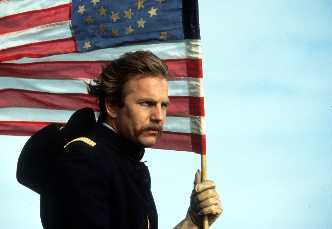 Kevin Costner holding an American flag in a scene from the film 'Dances With Wolves', 1990. (Getty Images)