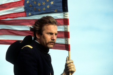 Kevin Costner holding an American flag in a scene from the film 'Dances With Wolves', 1990. (Getty Images)