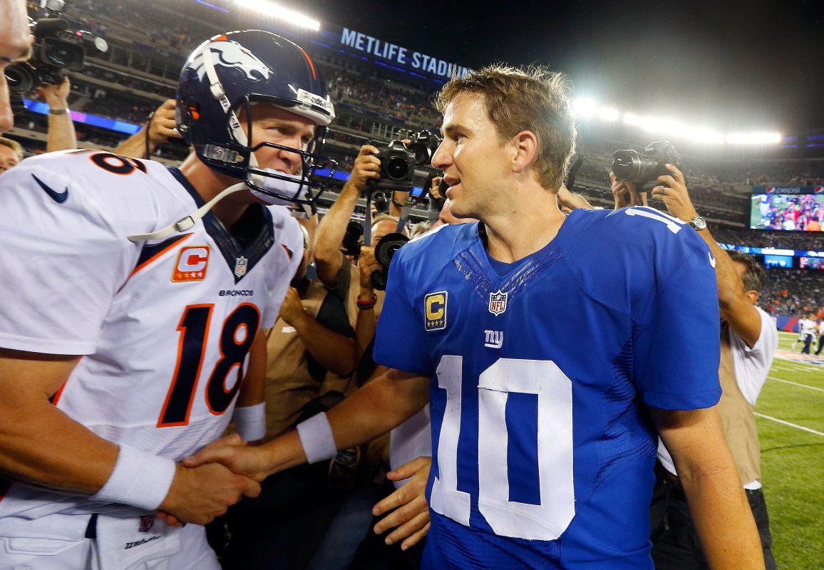 EAST RUTHERFORD, NJ - SEPTEMBER 15:  (NEW YORK DAILIES OUT)   Quarterbacks Peyton Manning #18 of the Denver Broncos and Eli Manning #10 of the New York Giants meet after their game on September 15, 2013 at MetLife Stadium in East Rutherford, New Jersey. The Broncos defeated the Giants 41-23.  (Photo by Jim McIsaac/Getty Images)