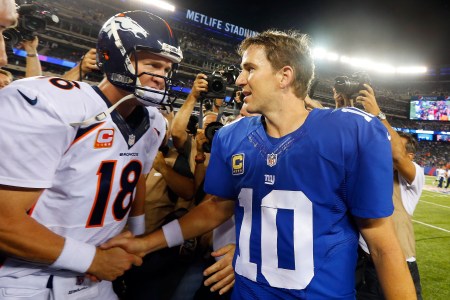 EAST RUTHERFORD, NJ - SEPTEMBER 15:  (NEW YORK DAILIES OUT)   Quarterbacks Peyton Manning #18 of the Denver Broncos and Eli Manning #10 of the New York Giants meet after their game on September 15, 2013 at MetLife Stadium in East Rutherford, New Jersey. The Broncos defeated the Giants 41-23.  (Photo by Jim McIsaac/Getty Images)