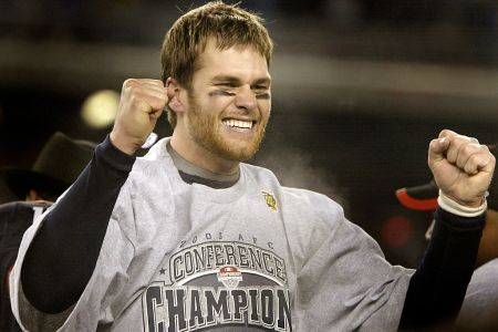 An exuberant Tom Brady on the AFC Championship podium following the New England Patriots' win over the Indianapolis Colts to advance to the Superbowl in Houston, TX. (Photo by Barry Chin/The Boston Globe via Getty Images)