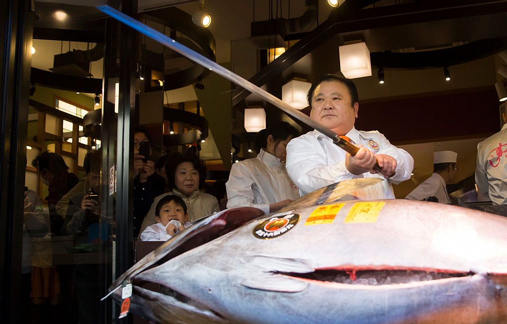 Kiyoshi Kimura poses with an endangered bluefin tuna before cutting it in front of one of the company's Sushi Zanmai sushi restaurants. He paid a record $3.1 million for a single fish at the annual New Year auction at Tokyo's Tsukiji market. (Photo by Tomohiro Ohsumi/Getty Images)