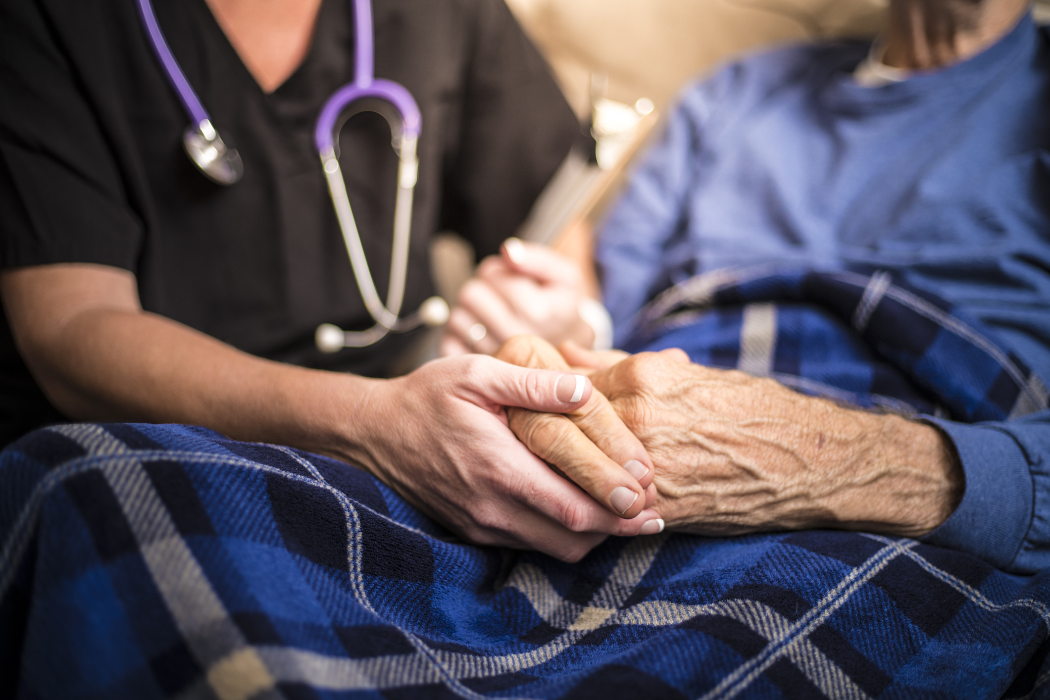 A hospice nurse visits an elderly patient. (Getty Images)