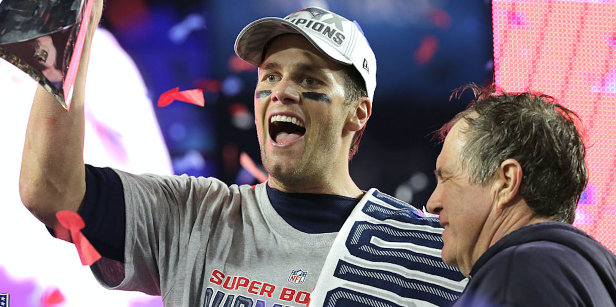 Patriots quarterback Tom Brady and coach Bill Belichick pose with the trophy at the post-game ceremony and celebration after the Patriots won Super Bowl XLIX. (Photo by Barry Chin/The Boston Globe via Getty Images)