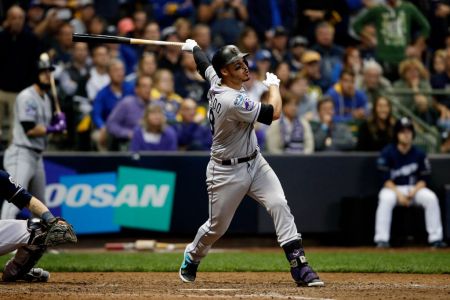 MILWAUKEE, WI - OCTOBER 4:  Nolan Arenado #28 of the Colorado Rockies hits a sacrifice fly in the ninth inning during Game 1 of the NLDS against the Milwaukee Brewers at Miller Park on Thursday, October 4, 2018 in Milwaukee, Wisconsin. (Photo by Mike McGinnis/MLB Photos via Getty Images)