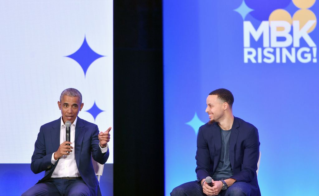 Former President Barack Obama (L) speaks alongside Golden State Warriors basketball player Stephen Curry (R) during the MBK Rising! My Brother's Keeper Alliance Summit in Oakland, California on February 19, 2019. (Photo by Josh Edelson / AFP)        (Photo credit should read JOSH EDELSON/AFP/Getty Images)