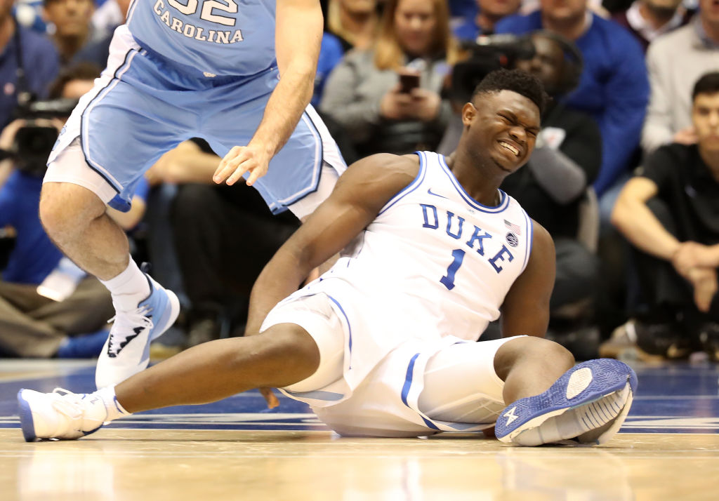 DURHAM, NORTH CAROLINA - FEBRUARY 20: (EDITORS NOTE: Retransmission with alternate crop.) Zion Williamson #1 of the Duke Blue Devils reacts after falling as his shoe breaks in the first half of the game against the North Carolina Tar Heels at Cameron Indoor Stadium on February 20, 2019 in Durham, North Carolina. (Photo by Streeter Lecka/Getty Images)