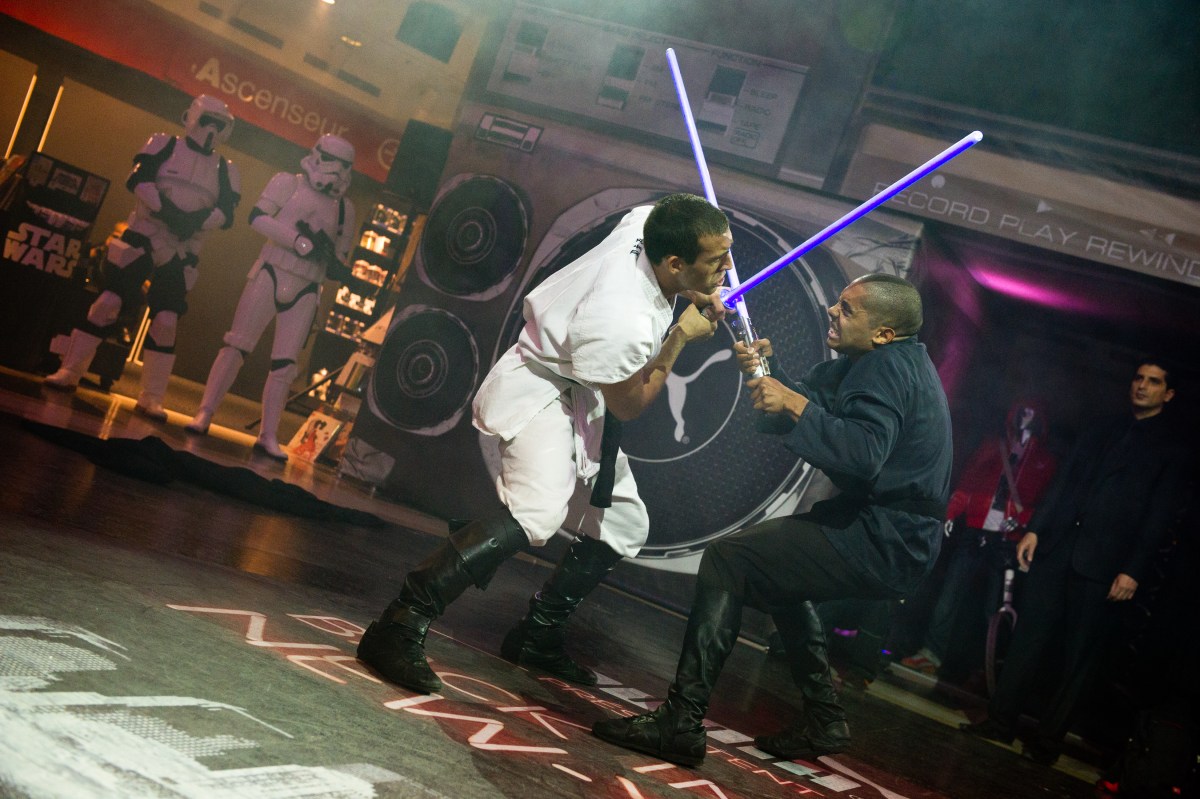 PARIS, FRANCE - SEPTEMBER 13: Cascade Demo Team members perform a Lightsaber fight at the Star Wars Saga release party at Virgin Megastore Champs-Elysees on September 13, 2011 in Paris, France. (Photo by Samuel Dietz/WireImage)