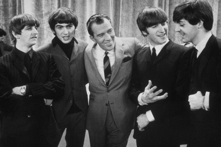 American television host Ed Sullivan smiles while standing with British rock group the Beatles on the set of his television variety series, New York, February 9, 1964. Left to right: Ringo Starr, George Harrison, Sullivan, John Lennon, Paul McCartney. (Photo by Express Newspapers/Getty Images)