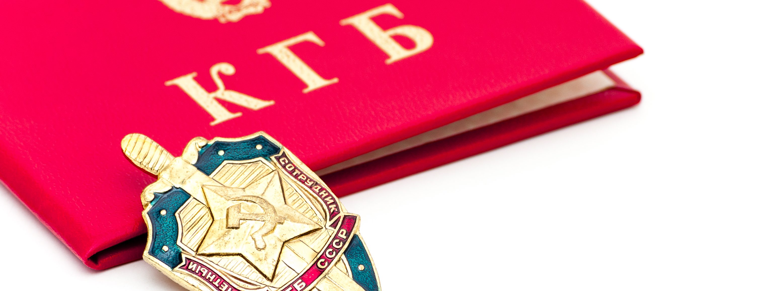 A KGB badge lays on a closed KGB identity book.   (Getty Images)