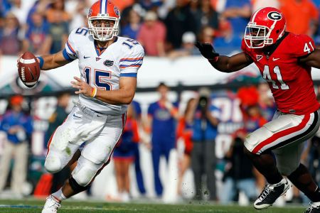 Florida quarterback Tim Tebow (15) scrambles as he is flushed from the pocket by Georgia defensive end Roderick Battle (41) in the Florida Gators 49-10 victory over the Georgia Bulldogs at Jacksonville Municipal Stadium in Jacksonville, FL. (Photo by Todd Kirkland /Icon SMI/Icon Sport Media via Getty Images)