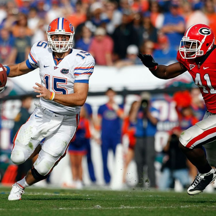 Florida quarterback Tim Tebow (15) scrambles as he is flushed from the pocket by Georgia defensive end Roderick Battle (41) in the Florida Gators 49-10 victory over the Georgia Bulldogs at Jacksonville Municipal Stadium in Jacksonville, FL. (Photo by Todd Kirkland /Icon SMI/Icon Sport Media via Getty Images)