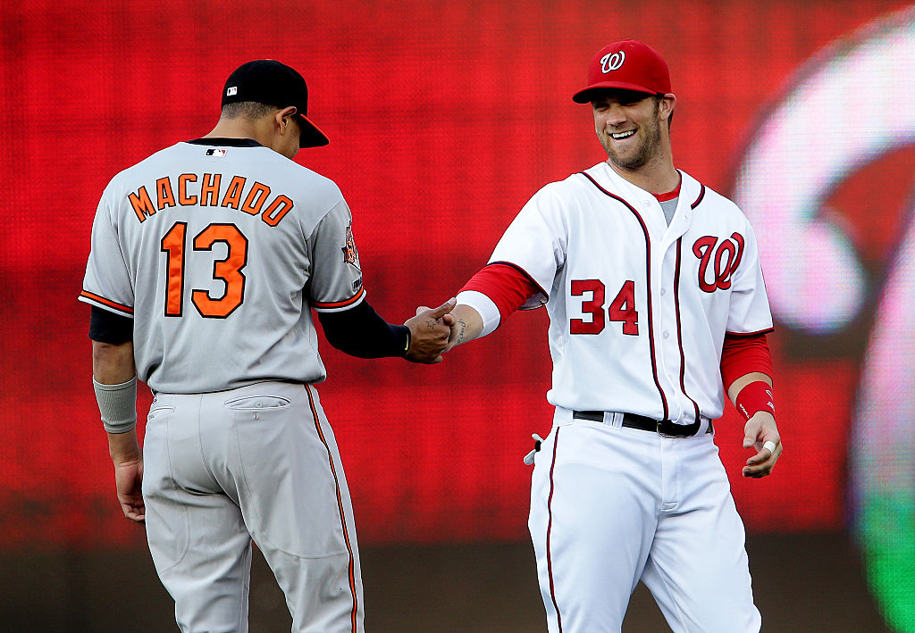  Washington Nationals left fielder Bryce Harper (34) greets Baltimore Orioles third base Manny Machado (13) before a MLB game at Nationals Park, in Washington D.C. (Photo by Tony Quinn/Icon SMI/Corbis via Getty Images)