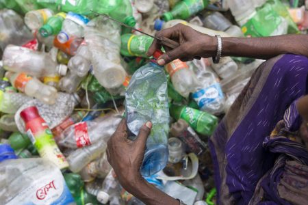 Female laborers sort through polyethylene terephthalate (PET) bottles in a recycling factory on July 06, 2017 in Dhaka, Bangladesh. (Zakir Chowdhury/Barcroft Images / Barcroft Media via Getty Images)