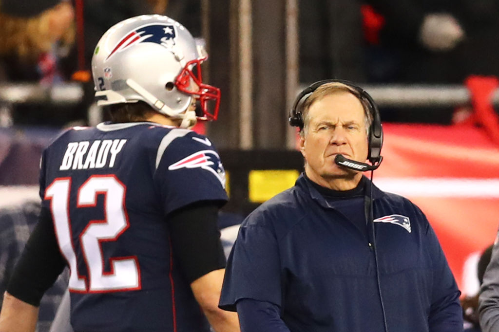 Head Coach Bill Belichick looks on as Tom Brady walks by during the AFC Championship Game in 2018. (Adam Glanzman/Getty)