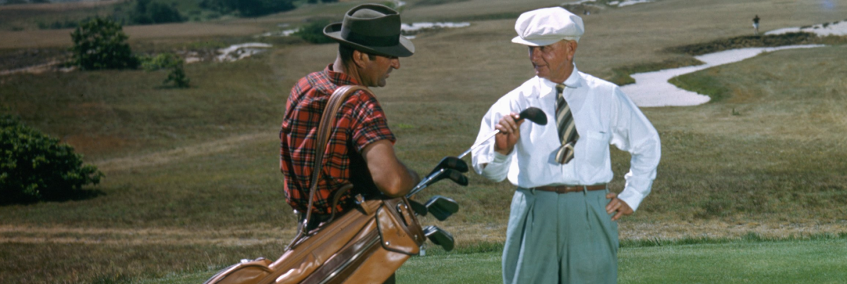 SOUTHAMPTON NY - 1950: A golfer and his caddy prepare to tee off at the National Golf Links of America Southampton New York in 1950. This photo was shot for the story 'America's Snootiest Golf Course' published in the April 22 1950 issue of the Saturday Evening Post. (Ivan Dmitri/Photo by Michael Ochs Archive/Getty Images)