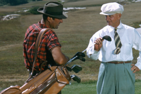 SOUTHAMPTON NY - 1950: A golfer and his caddy prepare to tee off at the National Golf Links of America Southampton New York in 1950. This photo was shot for the story 'America's Snootiest Golf Course' published in the April 22 1950 issue of the Saturday Evening Post. (Ivan Dmitri/Photo by Michael Ochs Archive/Getty Images)