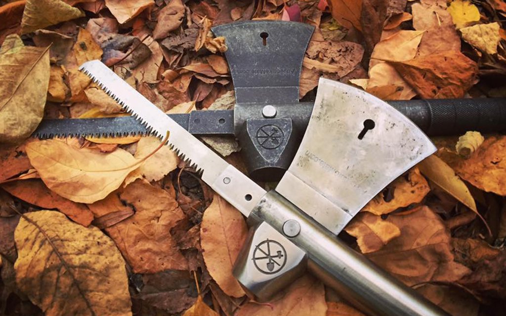 Two Adventure Mate hatchet multi-tools laying on a bed of leaves